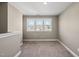 Neutral room featuring neutral paint and carpet, and a double window providing natural light at 178 Ashpole Trl, Clayton, NC 27520