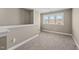 Neutral room featuring neutral paint and carpet, and a double window providing natural light at 178 Ashpole Trl, Clayton, NC 27520