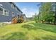 Beautiful backyard featuring a lush lawn, a deck, and a playground area at 1813 Lost Creek Ct, Apex, NC 27539