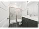Bathroom with a tiled shower, modern vanity, and neutral color scheme, offering a sleek and functional space at 1813 Lost Creek Ct, Apex, NC 27539