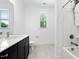 Clean bathroom featuring a tiled shower-tub, a toilet, and a modern vanity with quartz countertop at 1813 Lost Creek Ct, Apex, NC 27539