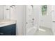 This is a bathroom with a blue vanity, a shower/bath and a sunny window at 1813 Lost Creek Ct, Apex, NC 27539