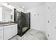 Modern bathroom featuring a grey tile shower with glass doors, a sink with vanity and marble floors at 1813 Lost Creek Ct, Apex, NC 27539