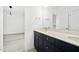 Bright bathroom featuring a double vanity with modern fixtures and a large mirror at 1813 Lost Creek Ct, Apex, NC 27539