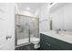 Modern bathroom features a glass-enclosed shower and a green vanity with a white countertop at 1813 Lost Creek Ct, Apex, NC 27539