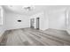 Bright bedroom with hardwood floors, recessed lighting, and doorways to closet and bathroom at 1813 Lost Creek Ct, Apex, NC 27539