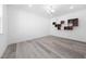 Minimalist bedroom with hardwood floors, white walls, and unique shelving at 1813 Lost Creek Ct, Apex, NC 27539