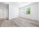 Bright bedroom with ample natural light, wood-look floors, and a view from the windows at 1813 Lost Creek Ct, Apex, NC 27539