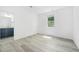 Light filled bedroom boasts wood floors and adjoins a full bathroom with dark blue cabinetry at 1813 Lost Creek Ct, Apex, NC 27539