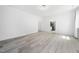 Spacious bedroom features a light grey wood floor and adjoins a full bathroom at 1813 Lost Creek Ct, Apex, NC 27539