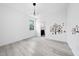 Sunlit bedroom with wood-look tile, contemporary lighting, and decorative owl wall art at 1813 Lost Creek Ct, Apex, NC 27539