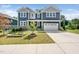 Beautiful two-story home showcasing its blue siding, stone accents, and well-manicured front yard at 1813 Lost Creek Ct, Apex, NC 27539