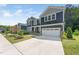 A two-story home displaying the blue siding, landscaping, driveway, and attached garage at 1813 Lost Creek Ct, Apex, NC 27539