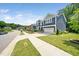 A two-story home displaying the blue siding, landscaping, driveway, and attached garage at 1813 Lost Creek Ct, Apex, NC 27539