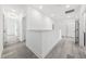 Upstairs hallway with wood-look tile, crisp white walls, and recessed lighting at 1813 Lost Creek Ct, Apex, NC 27539