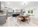 Open-concept kitchen features a central island with dining space seamlessly connecting to the dining and living areas at 1813 Lost Creek Ct, Apex, NC 27539