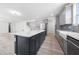 Bright kitchen with large island flows into an open-concept living area and dining room at 1813 Lost Creek Ct, Apex, NC 27539