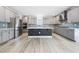 Stylish kitchen with stainless steel appliances, quartz countertops, and a large island at 1813 Lost Creek Ct, Apex, NC 27539