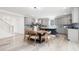 Eat-in kitchen features gray cabinets, center island, and wood table at 1813 Lost Creek Ct, Apex, NC 27539