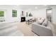 Open living room showcasing fireplace, large windows, and neutral decor at 1813 Lost Creek Ct, Apex, NC 27539