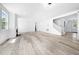 Open-concept living room featuring a fireplace, staircase, and light wood flooring throughout at 1813 Lost Creek Ct, Apex, NC 27539