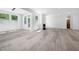 Bright living room with a fireplace, and hardwood floors, with French doors opening to the outside at 1813 Lost Creek Ct, Apex, NC 27539