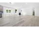 Spacious living room with modern light wood floors and a fireplace, perfect for entertaining at 1813 Lost Creek Ct, Apex, NC 27539