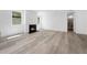 Cozy living room featuring a modern fireplace, hardwood floors, and neutral-toned walls at 1813 Lost Creek Ct, Apex, NC 27539