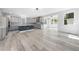 Modern living space with a breakfast nook, gray cabinets, an island and hardwood flooring at 1813 Lost Creek Ct, Apex, NC 27539