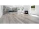 Open-concept living space with hardwood floors, fireplace, leading into the kitchen and dining area at 1813 Lost Creek Ct, Apex, NC 27539