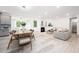 Bright, open concept living and dining space featuring fireplace and modern design at 1813 Lost Creek Ct, Apex, NC 27539