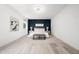 Bright primary bedroom features modern lighting, a dark accent wall, and stylish decor at 1813 Lost Creek Ct, Apex, NC 27539