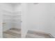 Walk-in pantry features bright white walls, wooden-look floors, and metal shelving at 1813 Lost Creek Ct, Apex, NC 27539