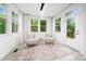 Inviting sunroom with large windows offers a serene space with ample natural light and views of the surrounding greenery at 1813 Lost Creek Ct, Apex, NC 27539