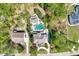 Aerial view of a property featuring the home, pool, manicured lawn and garden areas with mature trees at 187 Stoney Creek Way, Chapel Hill, NC 27517