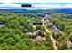 Aerial view of 187 Stoney Creek Wy in a neighborhood with mature trees near Jordan Lake at 187 Stoney Creek Way, Chapel Hill, NC 27517