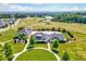 Aerial view showcases a pool and clubhouse amenity within a community surrounded by a golf course at 187 Stoney Creek Way, Chapel Hill, NC 27517