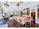 Spacious bar with seating, a stone facade, wood shelves, and tall ceilings in this luxurious living space at 187 Stoney Creek Way, Chapel Hill, NC 27517