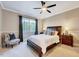 Comfortable bedroom features a wooden bed, ceiling fan, large window, and stylish decor at 187 Stoney Creek Way, Chapel Hill, NC 27517