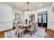 The dining room features elegant chandelier, wainscoting, and access to the outdoor living area at 187 Stoney Creek Way, Chapel Hill, NC 27517