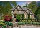 Beautiful two-story home with stone and brick facade, manicured landscaping, and a welcoming front porch at 187 Stoney Creek Way, Chapel Hill, NC 27517