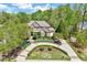 Beautifully landscaped home with a circular driveway and lush greenery at 187 Stoney Creek Way, Chapel Hill, NC 27517