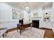 This home office features a fireplace, custom built-ins, and a large window for natural light at 187 Stoney Creek Way, Chapel Hill, NC 27517
