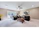Spacious living room featuring plush sofas, a ceiling fan, and a door that opens to the outdoors at 187 Stoney Creek Way, Chapel Hill, NC 27517