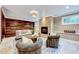 Cozy living room featuring a stacked stone fireplace, wood-paneled wall, plush seating, and stylish decor at 187 Stoney Creek Way, Chapel Hill, NC 27517