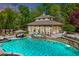 Stunning pool area with a sunroom, an in-ground jacuzzi, a pool-side table, and plenty of lounge seating at 187 Stoney Creek Way, Chapel Hill, NC 27517