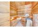 Relaxing sauna room with wooden benches, soft lighting, and a modern sauna heater at 187 Stoney Creek Way, Chapel Hill, NC 27517