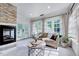 Cozy sitting room with fireplace and French doors leading to an outdoor area at 187 Stoney Creek Way, Chapel Hill, NC 27517