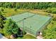 View of the community tennis courts surrounded by greenery; stay active in this outdoor space at 187 Stoney Creek Way, Chapel Hill, NC 27517