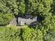 Overhead view of a charming house enveloped by vibrant green trees at 2001 Lovdal Dr, Raleigh, NC 27613